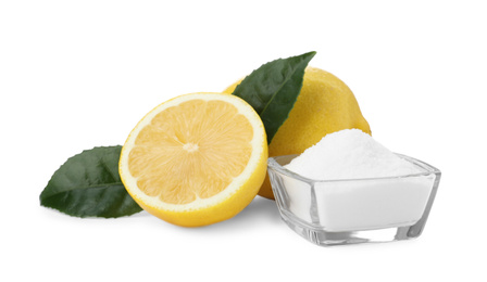 Baking soda and cut lemons on white background