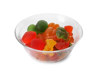 Different delicious gummy candies in glass bowl on white background