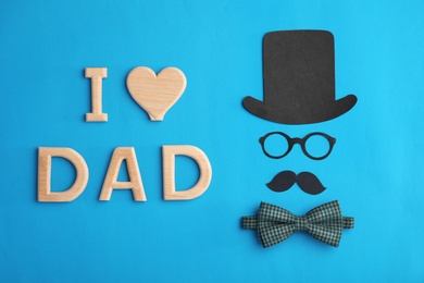Flat lay composition with paper decor and bow tie on color background. Happy Father's Day