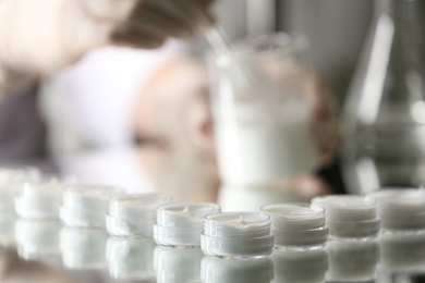 Small jars with cream in cosmetic laboratory