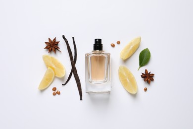 Photo of Flat lay composition with bottle of perfume, spices and lemon on white background