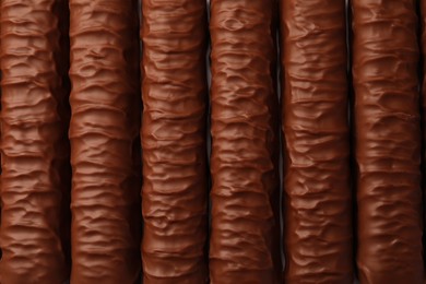 Photo of Sweet tasty chocolate bars as background, top view