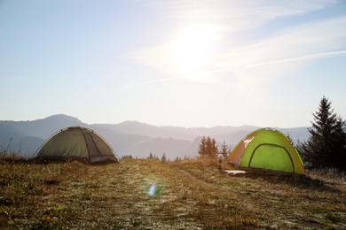 Photo of Beautiful camping tents in mountains on sunny day
