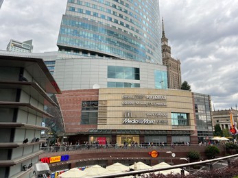 Photo of WARSAW, POLAND - JULY 17, 2022: Big shopping mall and beautiful buildings under cloudy sky