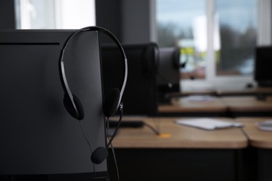 Modern computer with headset in office. Hotline service