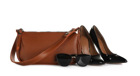 Brown women's mini bag, shoes and sunglasses on white background
