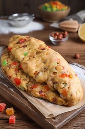 Unbaked Stollen with candied fruits and raisins on wooden table, closeup