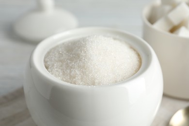 Photo of Ceramic bowl with white sugar, closeup view