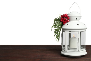Christmas lantern decorated with coniferous twigs and berries on grey background, space for text