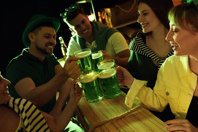 People with beer celebrating St Patrick's day in pub