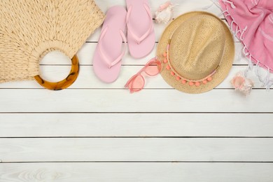 Photo of Flat lay composition with beach objects on white wooden background, space for text
