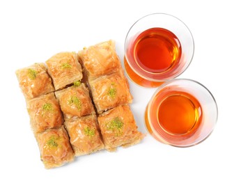 Delicious baklava with pistachios and hot tea on white background, top view