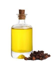 Essential oil and dried cloves on white background