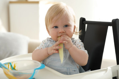Photo of Cute little baby eating vegetable at home. Healthy food