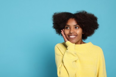 Photo of Portrait of smiling African American woman on light blue background. Space for text