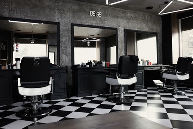 Stylish monochrome interior of modern barbershop. Equipped workplace