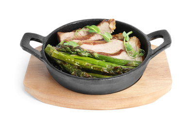 Tasty meat with asparagus and sprouts in portioned frying pan isolated on white