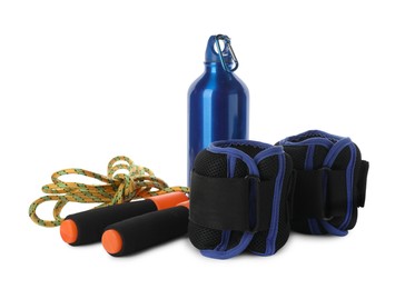 Stylish weighting agents, skipping rope and sport bottle on white background