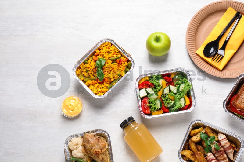 Lunchboxes on white wooden table, flat lay. Healthy food delivery