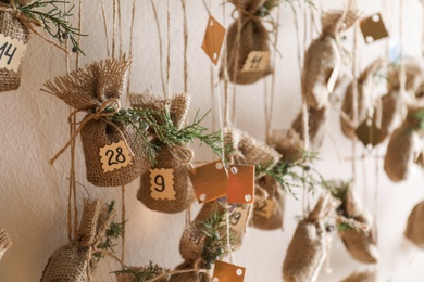 New Year advent calendar hanging on beige wall indoors, closeup