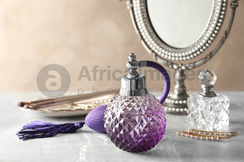 Different elegant perfume bottles on dressing table