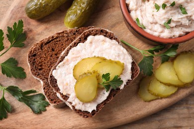 Sandwich with delicious lard spread and pickles on wooden board, flat lay
