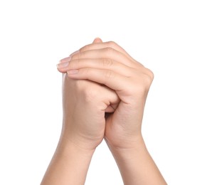 Woman holding hands clasped while praying on white background, closeup