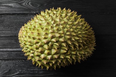 Ripe durian on black wooden table, top view