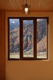 Photo of Beautiful view of mountains from clean window indoors
