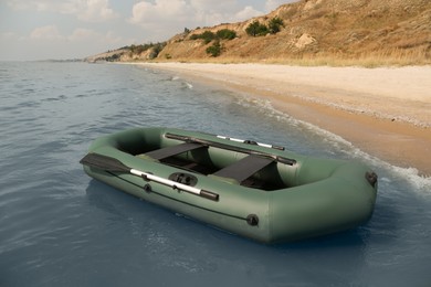 Inflatable rubber fishing boat floating in sea near coast