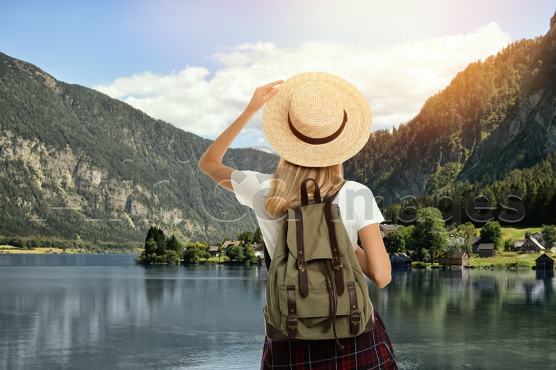 Image of Tourist with travel backpack enjoying mountain landscape during summer vacation trip