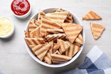 Photo of Delicious pita chips on white wooden table, flat lay