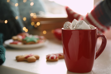 Cup of delicious hot cocoa with marshmallows on white table. Winter drink