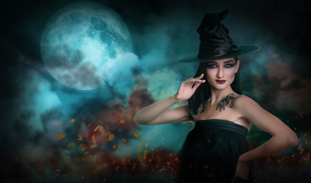 Young girl dressed as witch with creepy spider on full moon night. Halloween fantasy