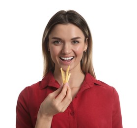 Young woman eating French fries on white background