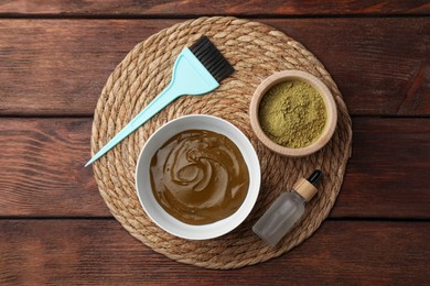 Photo of Composition with henna powder and cream on wooden table, top view. Natural hair coloring