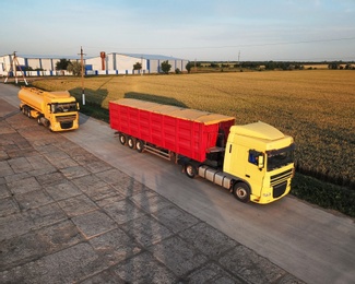 Modern bright trucks parked on country road