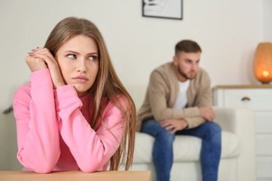 Young couple ignoring each other after argument in living room. Relationship problems