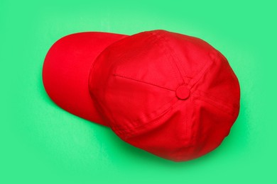 Baseball cap on green background, top view. Mock up for design