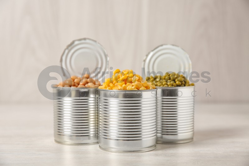 Open tin cans with conserved vegetables on light table