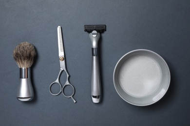 Set of men's shaving tools on dark grey background, flat lay