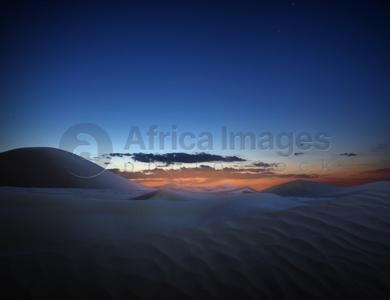 Scenic view of sandy desert at sunset 