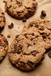 Photo of Delicious chocolate chip cookies on parchment paper