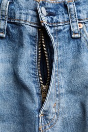 Blue jeans with unbuttoned fly as background, top view. Exhibitionist concept