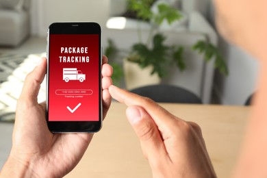 Man tracking parcel via smartphone indoors, closeup