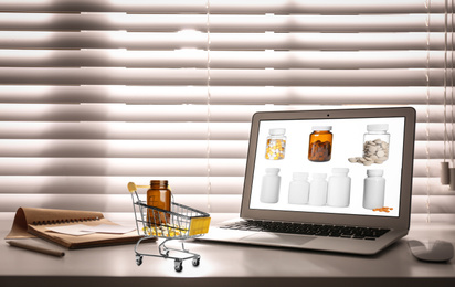 Image of Ordering medications online. Modern laptop on table indoors