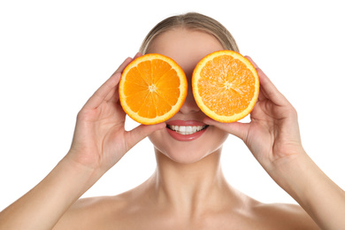 Photo of Young woman with cut orange on white background. Vitamin rich food