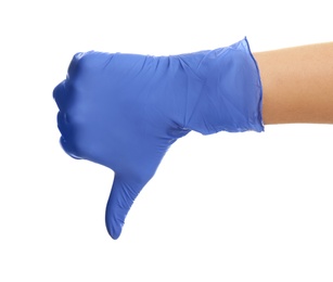 Woman in blue latex gloves showing thumb down gesture on white background, closeup of hand