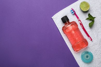 Composition with mouthwash and other oral hygiene products on purple background, top view. Space for text