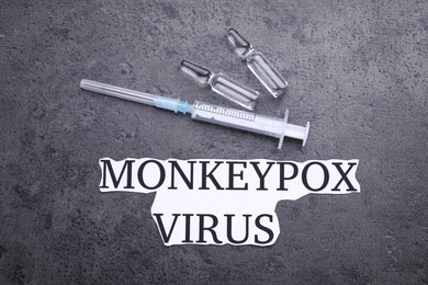 Words Monkeypox Virus, syringe and vials on grey table, flat lay